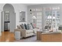 Open-concept living room featuring a comfortable sofa, hardwood floors, and view to the kitchen at 4565 Club Ne Dr, Atlanta, GA 30319