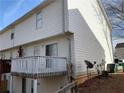 Rear exterior with a deck, sliding glass door, white siding, and access to ground floor at 5047 Chupp Way Cir, Lithonia, GA 30038