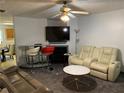 Cozy living room featuring modern decor, comfortable seating, ceiling fan and a fireplace at 5047 Chupp Way Cir, Lithonia, GA 30038