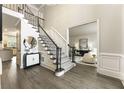 Elegant foyer with hardwood floors, staircase, and views into the living room and kitchen at 832 Forest Path Ln, Alpharetta, GA 30022
