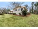 A charming single-story brick home with lush lawn and manicured shrubbery at 1385 Lucky Sw Ln, Mableton, GA 30126