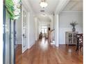 Elegant foyer featuring hardwood floors, wainscoting, and a view of the staircase at 4815 Westgate Dr, Cumming, GA 30040