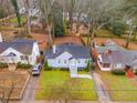 Aerial view of a well-maintained home nestled among mature trees, featuring a green lawn at 1318 Beecher St, Atlanta, GA 30310