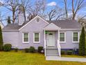 Charming home featuring a light grey brick facade, well-kept lawn, and welcoming front entrance at 1318 Beecher St, Atlanta, GA 30310