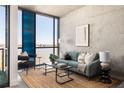 Living room showcasing a comfortable blue sofa, stylish coffee table, and large windows with a view at 480 John Wesley Dobbs Ne Ave # 810, Atlanta, GA 30312