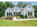 Charming two-story home with manicured lawn and beautiful landscaping; home has a welcoming porch at 2861 Digna Ct, Acworth, GA 30101