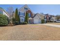 Inviting two-story home with a well-manicured lawn and mature trees at 3624 Bancroft Main Nw, Kennesaw, GA 30144