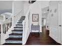 Bright foyer with hardwood floors and a staircase with patterned risers at 3624 Bancroft Main Nw, Kennesaw, GA 30144