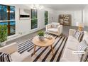 Bright living room with large windows, a stylish rug, and comfortable seating for relaxing at 4726 Alpine Sw Dr, Lilburn, GA 30047