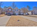 Exterior shot of townhomes featuring attached garages, well-maintained lawns and driveways at 151 Creekwood Dr, Woodstock, GA 30188