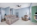 Comfortable living room featuring a recliner sofa, accent chair, and neutral carpet at 151 Creekwood Dr, Woodstock, GA 30188