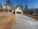 New construction home featuring a two-car garage and a long concrete driveway at 200 Brookwood Xing, Douglasville, GA 30134