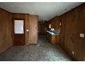 Functional kitchen space with wood paneling, sink, and door to the outside, ready for customization at 3450 Estes Dr, Atlanta, GA 30349