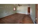 Spacious living room featuring hardwood floors, natural light, and a ceiling fan for added comfort at 3450 Estes Dr, Atlanta, GA 30349