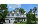 Beautiful two-story home with dormer windows, a well-maintained lawn, and an attached two-car garage at 200 Edinburgh Ln, Woodstock, GA 30188