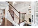 Inviting foyer with hardwood floors, staircase, and elegant decorative touches at 3557 Ashcroft Se Dr, Smyrna, GA 30080