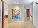 Bright foyer with hardwood floors and colorful floral art creating an inviting ambiance at 4599 Park Dr, Pine Lake, GA 30083