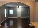 Spacious living room with hardwood floors, a large archway, and a ceiling fan at 1466 Andrews Nw St, Atlanta, GA 30314