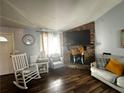 Welcoming living room showcasing a stone fireplace, hardwood floors, lots of light, a ceiling fan, and comfortable furniture at 3356 Hollow Ct, Lawrenceville, GA 30044