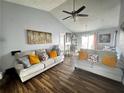 Inviting living room featuring vaulted ceilings, hardwood floors, two comfortable sofas, and stylish decor with natural light at 3356 Hollow Ct, Lawrenceville, GA 30044