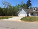 Lovely exterior showcasing a two-car garage and well-maintained landscaping at 183 Brookwood Xing, Douglasville, GA 30134