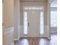 Bright home entryway featuring beautiful front door, decorative trim, and hardwood floors at 2700 Ogden Trl, Buford, GA 30519