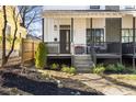 Inviting front yard and entrance with black trim, garden bed and walkway to the porch at 593 Formwalt Sw St, Atlanta, GA 30312