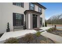 Inviting front entrance with black shutters and decorative benches that add curb appeal to this beautiful home at 1461 Thomas St, Conyers, GA 30094