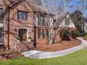 Close up of a beautiful brick home featuring a well-manicured lawn and an inviting front entrance at 790 Denards Se Ml, Marietta, GA 30067