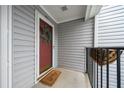 Upstairs condo with a welcoming entryway, gray siding, and front door with storm door at 14 Hampshire Ct, Avondale Estates, GA 30002