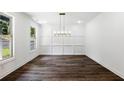 Bright dining room with wainscotting detail, hardwood floors, and natural light at 110 Jackson St, Buford, GA 30518