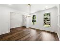 Bright, white dining room featuring hardwood floors, natural light and decorative lighting at 110 Jackson St, Buford, GA 30518