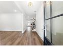Bright entryway featuring wood-look flooring, chandelier lighting and modern glass door at 110 Jackson St, Buford, GA 30518