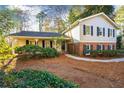 Inviting home with charming facade, manicured landscaping and a stone walkway, creating a welcoming curb appeal at 1105 Orchard Way, Roswell, GA 30075
