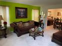 Living room with lime green wall, plush sofa and decorative lighting at 2270 Exchange Se Pl, Conyers, GA 30013