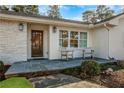 Inviting front porch featuring slate flooring, quaint seating, and charming curb appeal at 834 Kipling Nw Dr, Atlanta, GA 30318