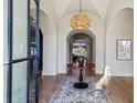 Elegant foyer with a woven chandelier, a round wooden table, a patterned rug, and herringbone floors at 1297 Swims Valley Nw Dr, Atlanta, GA 30327