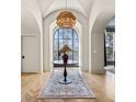 Grand foyer with a large window, modern light fixture, wood floors, and an elegant area rug at 1297 Swims Valley Nw Dr, Atlanta, GA 30327