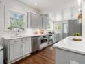 Bright kitchen featuring stainless steel appliances, gray cabinets, and white countertops at 427 S Columbia Dr, Decatur, GA 30030