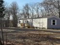 Exterior of home with new wooden deck, surrounded by a natural landscape at 155 Emily Drive, Whitesburg, GA 30185