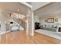 Spacious foyer featuring hardwood floors, a staircase with wrought iron details, and a comfortable sitting area at 3001 Prestwyck Haven Dr, Duluth, GA 30097