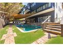 Backyard swimming pool with stone waterfall feature, surrounded by lush landscaping and brick pavers at 1812 Hunters Gln, Marietta, GA 30062