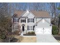 Beautiful two-story home boasts stone accents, black shutters, and a well-maintained front yard at 328 Wickley Way, Woodstock, GA 30188