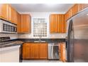Kitchen features stainless steel appliances, wood cabinets, granite countertop, and a window at 10 Perimeter Summit Ne Blvd # 3204, Atlanta, GA 30319