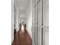 Inviting hallway features hardwood floors, neutral paint, and a clear view to the back of the home at 1872 Commons Nw Pl, Atlanta, GA 30318
