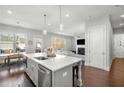 Modern kitchen with stainless steel appliances, quartz countertops and hardwood floors at 1872 Commons Nw Pl, Atlanta, GA 30318