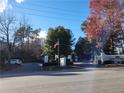Community entrance with sign, flag, and mature trees, enhancing the property's appeal at 2201 Pine Heights Ne Dr, Atlanta, GA 30324