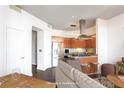 Bright kitchen featuring stainless steel appliances and granite countertops, open to a cozy living area at 2626 Peachtree Nw Rd # 1102, Atlanta, GA 30305