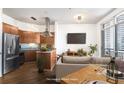 Living area featuring wood floors, kitchen with stainless steel appliances, and a comfortable sofa at 2626 Peachtree Nw Rd # 1102, Atlanta, GA 30305