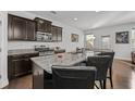 Modern kitchen island with granite countertops, stainless steel appliances, and dark wood cabinetry at 5512 Cascade Sw Run, Atlanta, GA 30336